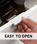 Hand using 5 Pack 3 Inch Self Adhesive Cabinet Pulls Silver Stick On Handles No Drill Concealed Edge Drawer