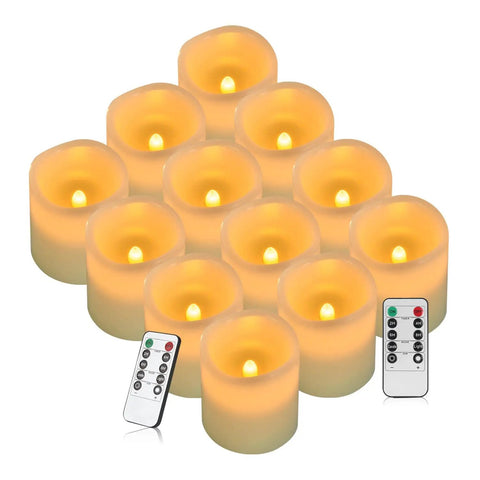 Flameless Battery Operated Pillar Candles Set Of 12 Real Wax Pillars With Dancing LED Flames 3 Inch By 4 Inch Ivory displayed with remotes