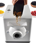 Top Shelf Home Coffee Bean And Peanut Roaster With Auto Rolling Drum, user pouring coffee beans into the machine.