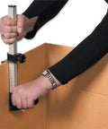 Person using Box Resizer Tool With Scoring Wheel For Cardboard Boxes And Shipping Boxes, adjusting cardboard box size.