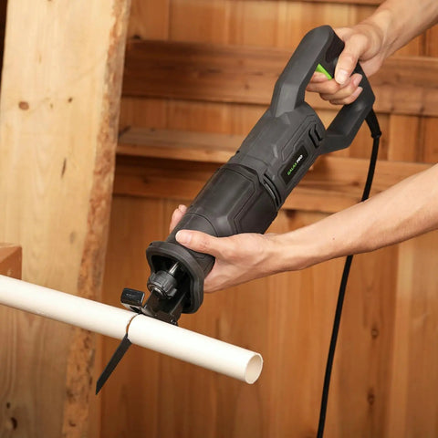 User operating a Heavy Duty Corded Reciprocating Saw 120V With 6.0 Amp Motor And 2800 RPM cutting PVC pipe.