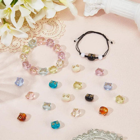 Colorful Acrylic Cat Beads Kit 100 Pcs displayed with bracelets and loose 3D cat face spacers for jewelry making and DIY crafts.