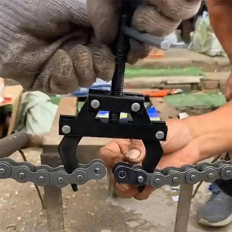 Beefy Chain Breaker Tool For 100 To 200 Roller Chains in action on a roller chain, showing heavy duty two-claw design.