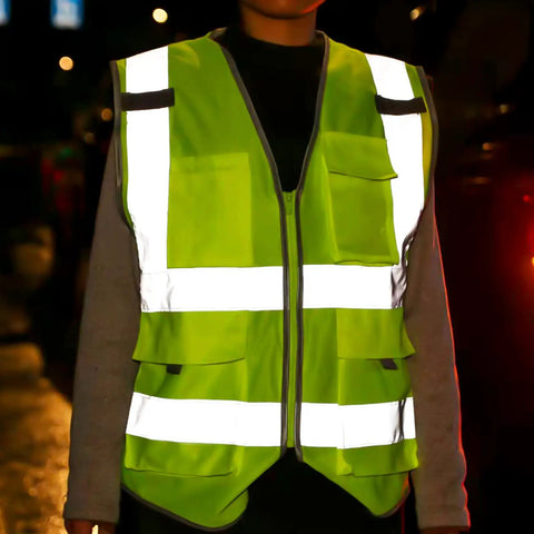6 Pack High Visibility Reflective Work Vests For Men And Women, 8 Pockets With Zipper, shown in low light with reflective strips