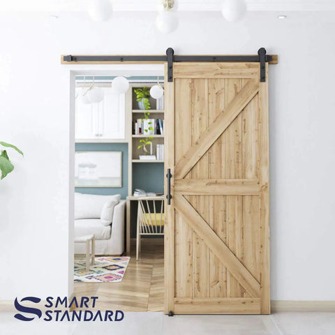 Heavy Duty Sliding Barn Door Hardware Kit In Black shown on wooden door, includes pull handle set and floor guide