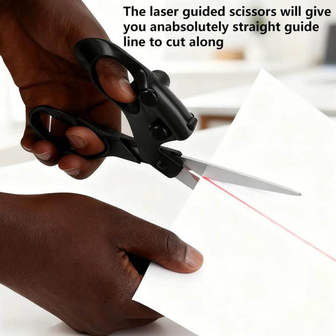 Close-up of professional laser guided scissors with ergonomic black handles cutting white paper; red laser line visible.