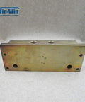 Hydraulic manifold block for waterjet top-mount intensifier pump; metal with threaded top ports and mounting holes.