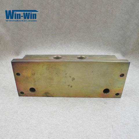 Hydraulic manifold block for waterjet top-mount intensifier pump; metal with threaded top ports and mounting holes.