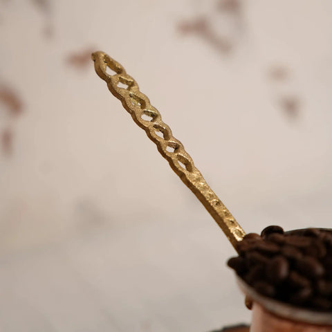 Close-up of handle on Arabic Coffee Pot Cezve Turkish Coffee Maker For 3 Cups Medium Size With Hammered Copper Exterior And Stainless Steel