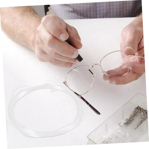 Hands repairing glasses with Eyeglass Repair String For Half Frame Glasses Compact Lightweight Maintenance Tool With Nylon Thread.