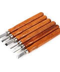 Wood Carving Tools Set With Knife And Mini Chisels Dope High Carbon Steel Blades Ergonomic Wooden Handles Built For DIY Woodworking Woodcut And Sculpture Projects 6 Piece Kit shown with ergonomic wooden handles laying on white surface