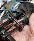 Two Claw Bearing Puller Tool for Auto Maintenance and Car Repair being used on a bearing in a workshop setting