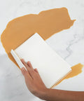 Spiff Cloth 4-Count Miracle Cleaning Towels, white reusable cleaning cloth wiping orange liquid spill on marble