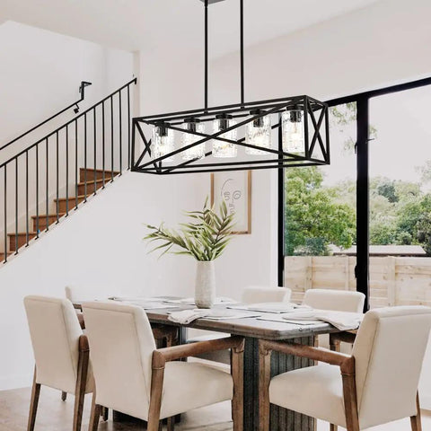 Boss Level Farmhouse Linear Chandelier With Textured Seedy Glass Shades Five Light Kitchen Island And Dining Room Lighting Fixture Matte Black Finish Adjustable Rods For Living Room And More above a dining table in a modern setting.