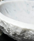Close-up view of Durable Modern Oval Marble Vessel Sink Handcrafted From Real Natural Stone Above Counter Bathroom Vanity Bowl.