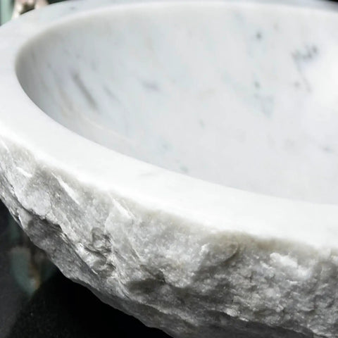Close-up view of Durable Modern Oval Marble Vessel Sink Handcrafted From Real Natural Stone Above Counter Bathroom Vanity Bowl.