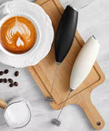 Automatic Milk Frother Wand For Lattes And Cappuccinos, Battery Operated Handheld Foam Maker on Cutting Board with Latte and Beans