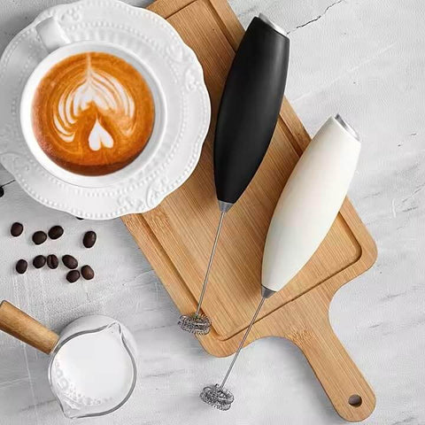 Automatic Milk Frother Wand For Lattes And Cappuccinos, Battery Operated Handheld Foam Maker on Cutting Board with Latte and Beans