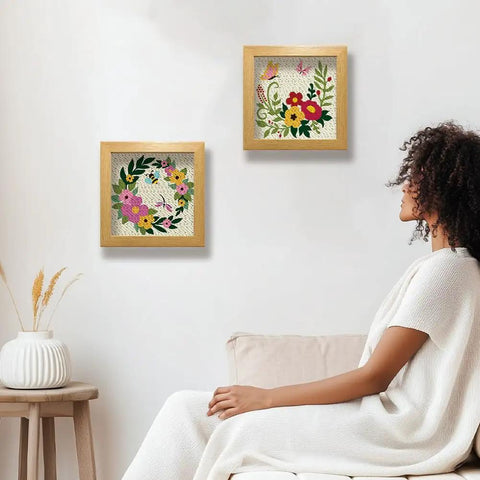 Two Pack Flower Butterfly Punch Needle Kit Set With Frames For Beginners displayed on wall, 9.4 by 9.4 inches, flowers and butterflies pattern.