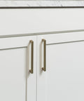 Beefy Solid Core Cabinet Pulls With 18 Inch Center Elusive Golden Nickel Finish on white cabinet doors.