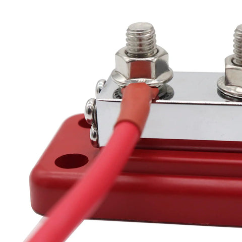 Hella Heavy Duty Copper Bus Bar Providing 600 Amp Juice For Rock Solid 8 Way Distribution Block Grounding And Smooth Auto Battery Wiring In Classic Red And Black, close-up showing connection.