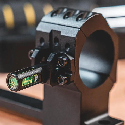 One Piece Bolt Action Scope Mount With Thirty Mil Medium Rings For Remington Seven Hundred Short Action showing level bubble and structural support.