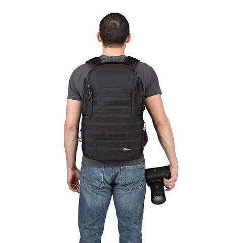 Man wearing ProTactic 450 AW II Camera Backpack With All Weather Cover for DSLR, mirrorless, drone gear, and 15-inch laptop.