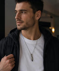 Man wearing Mini Pencil EDC Pendant With Infinite Keychain, a compact graphite pencil necklace for quick notes, sketches, labels.