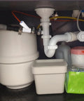 Universal Dishwasher Drain Hose Adapter Kit For RO Water Systems installed under sink with white fittings and hoses.