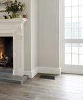 Living room with Scroll Design Floor Register 4x10 in Textured Black 8 Pack Decorative Steel Floor Vent on wooden floor near fireplace.