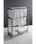 Edenscape Freestanding Towel Rack In Brushed Nickel With Solid Steel Construction Triple Towel Bar Design Generous Bottom Shelf Storage Corrosion Resistant Finish Multi Tier Bath Organizer Stand with towels on bars and shelf on white tile floor.