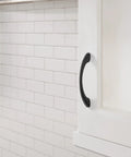 Vaile Matte Black Cabinet Pull 3-3/4 Inch Center to Center installed on a white cabinet, showcasing modern drawer handle.