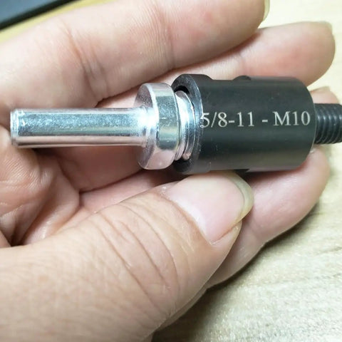 Slick Two Pack 5811 Male Thread To Quarter Inch Round Shank Drill Adapter shown in hand, featuring steel construction for electric grinders.