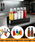 Two Pack Magnetic Spray Bottle Holder With Four Hooks, Wall Mounted Organizer For Garage And Home, Heavy Duty Metal Rack For Spray Cans, Tools, And Craft Space, Space Saving Black Finish on a workbench with spray cans