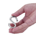 Hand holding an S-shaped hook from Garage Door Cable And Pulley Replacement Kit With Two Pairs Of Galvanized Aircraft Cables And Four Heavy Duty Three Inch Pulleys And Fasteners For Torsion And Extension Doors Up To 12 And 9 Feet DIY Ready