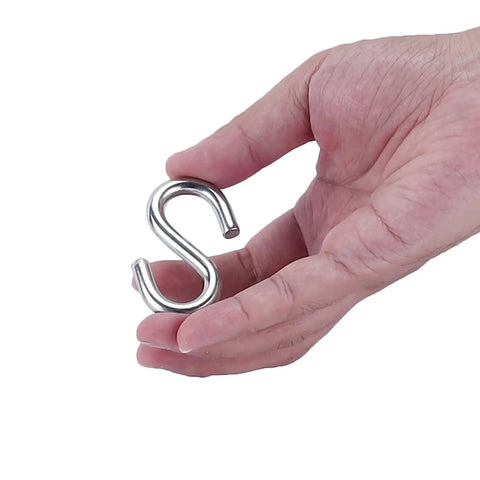 Hand holding an S-shaped hook from Garage Door Cable And Pulley Replacement Kit With Two Pairs Of Galvanized Aircraft Cables And Four Heavy Duty Three Inch Pulleys And Fasteners For Torsion And Extension Doors Up To 12 And 9 Feet DIY Ready