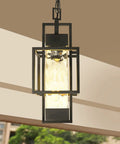 Top Tier 15 Inch Outdoor Indoor Pendant Light Featuring Heavy Duty Black Metal And Thick Water Seeded Glass hanging in foyer.