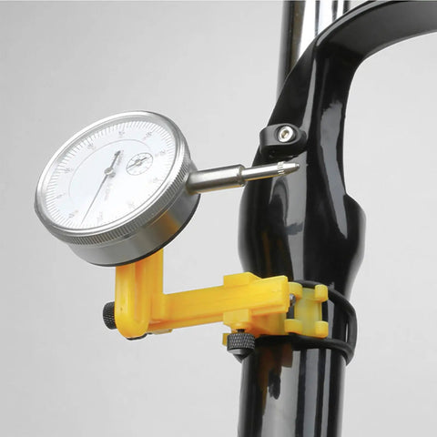 Pro Grade Wheel Turning Stand With Dial Indicator For Precise Bike Wheel Alignment And Repair At Home, close-up of dial gauge.