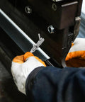 Worker using Bulletproof L Handle Lock Pin Stainless Steel Safety Plunger M10 L Shape cabinet fastener for assembly.