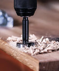 Five Piece Forstner Drill Bit Set With Rugged Three Flat Shank Grip on hardwood creating shavings during blind hole drilling.