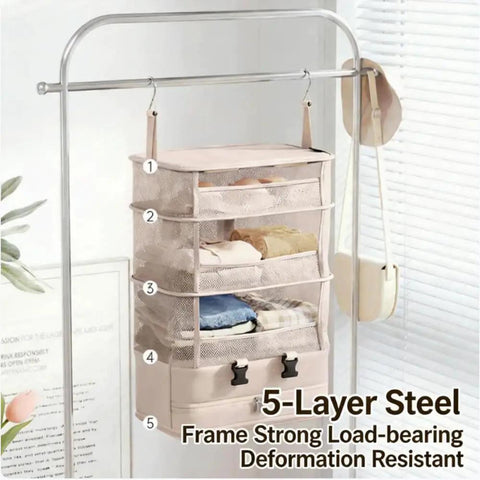 Heavy Duty Hanging Travel Shelf Bag Organizer For Luggage Suitcase With Ventilated Mesh Pockets And Water Repellent Nylon Fabric Badass Carry On Organizer In Purple hanging on a steel rack with folded clothes.