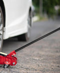 Heavy-duty 3 Ton Jack Handle Replacement for horizontal hydraulic jack in use on road, built with carbon steel and non-slip grip.