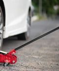 Beefy Floor Jack Handle Replacement For 3 Ton Horizontal Hydraulic Jacks Steel And Rubber Construction Durable Auto Repair Accessory Easy Fit Pole Lever in use on a car