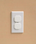 Electrical outlet with white covers from Home Safety Essentials Kit For Kids With 46 Pieces Including Door Knob Covers And Cabinet Latches