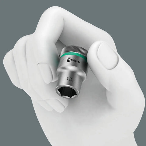 Hand holding a 13mm hex socket. Similar to Zyklop 8790 HMB Three Eighths Inch Socket With Hex Head 18mm and 29mm Length Ball Intercept Ring.