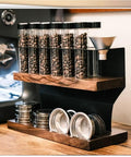 Top Shelf Solid Wood And Carbon Steel Single Dose Coffee Bean Storage Rack With One Way Vent Valve holding coffee beans and gear