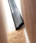 Mini Dust Brush Vacuum Attachment Kit cleaning tight space between wood surfaces.