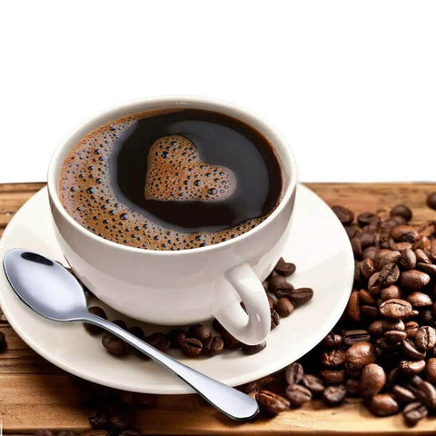 Coffee cup with heart-shaped foam next to a Demitasse Espresso Spoon Set Of 6, Mini Stainless Steel Coffee Spoons For Tea Dessert And After Dinner.