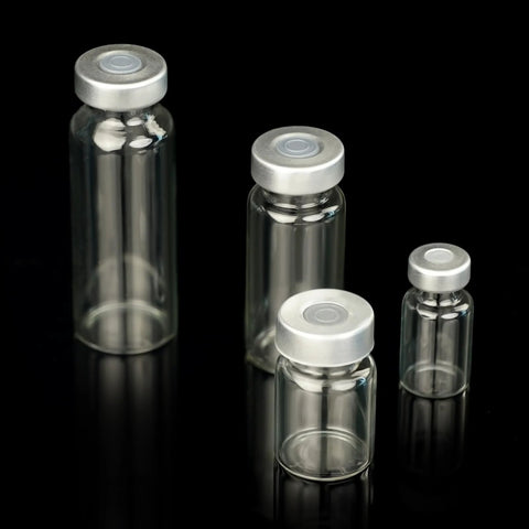 Four 2mL transparent glass sample vials with silver caps