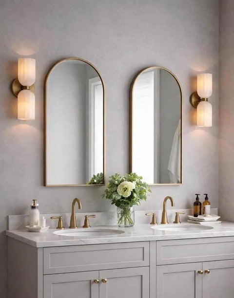 GLEAMING NEST Modern Alabaster Wall Sconce, Double Light Fixture, Antique Brass Finish, Fluted Stone Shades illuminating a bathroom vanity.